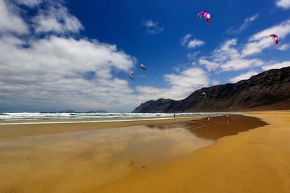 Famara, Lanzarote. Otro lugar donde disfrutar de largas temporadas surfistas, sin importar los caprichos de las estaciones, es Lanzarote. Al norte se encuentra la playa de Famara, que tiene un agradable fondo de arena en pleno territorio volcánico. Rodeada de un entorno natural privilegiado, sus cinco kilómetros de longitud suelen ser batidos por los vientos, lo que también la convierte en un escenario privilegiado para aprender kitesurf o windsurf.  