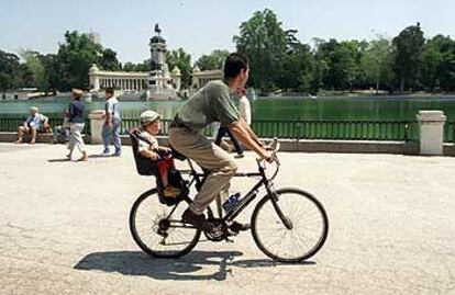 Paseo en bicicleta, con un niño, por el parque del Retiro de Madrid.