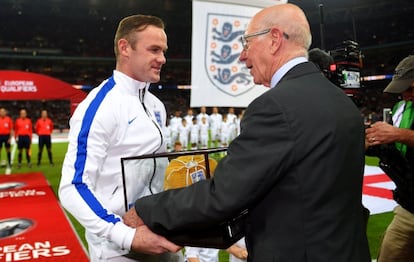 Charlton entrega una gorra dorada a Rooney por su centenario.