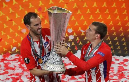 Diego Godin y Antoine Griezmann sujetan el trofeo de la Europa League.