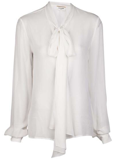Todo armario que se precie no puede prescindir de un clásico: la blusa con maxi lazada de aire romántico. Este modelo es de Saint Laurent (1.462 euros).