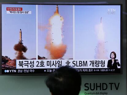 Homem vê uma televisão que transmite imagens do lançamento de um míssil na Coreia do Norte.