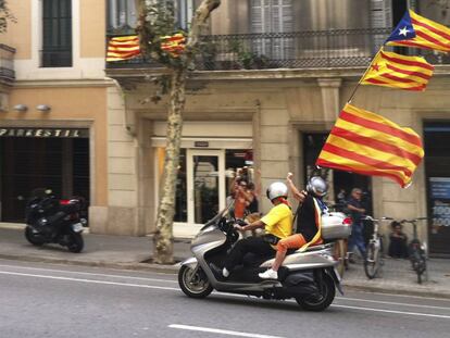 Dos joves porten banderes catalanes durant la Diada del 2012.