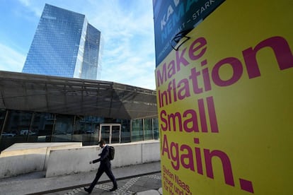 A man walks past an pre-election banner reading