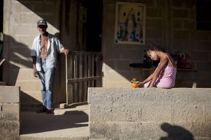 A girl and her grandfather in a house built with government support for descendants of slaves in Eldorado, S&atilde;o Paulo state. 