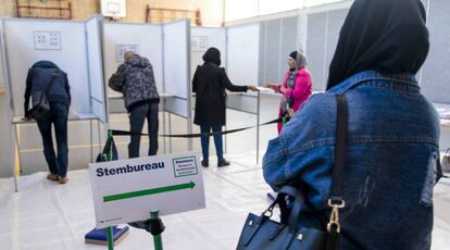 Ciudadanos depositan sus votos en unas cabinas durante las elecciones parlamentarias, en Rotterdam (Holanda).