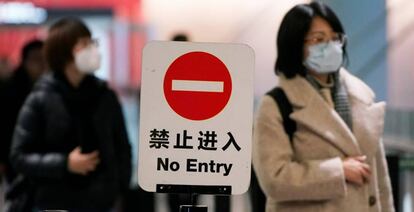 Pasajeros con máscaras en el aeropuerto internacional Hongqiao, en Shanghái (China), el lunes.