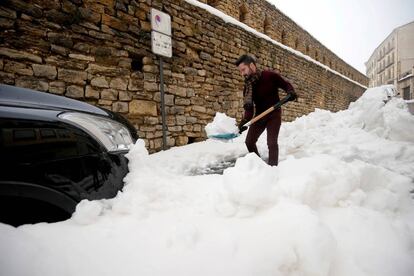 A man shoveling snow in Morella, in the Valencia region.