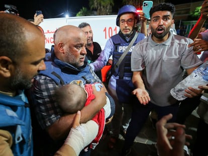 Al Jazeera's correspondent in Gaza, Wael Dahdouh, holds in his arms the body of one of his sons, killed with his wife and daughter in an Israeli bombing, at the al-Aqsa hospital in the south of the Strip, on October 25, 2023.