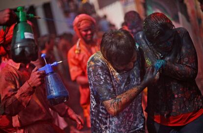 No hay que olvidar que culturalmente Holi es un día para olvidar los errores del pasado, en el que se perdonan las deudas a la gente, un día para olvidar los problemas. En la imagen, una pareja corre a cubierto cuando los niños les rocían con agua de color durante la fiesta religiosa de Holi dentro de un templo en la aldea de Nandgaon, en el estado de Uttar Pradesh (India), el 25 de febrero de 2018.