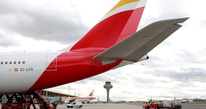 Un avi&oacute;n con la nueva imagen de Iberia en la T4 de Barajas. Al fondo se apreia un aparato con el antiguo logotipo./ P. Monge