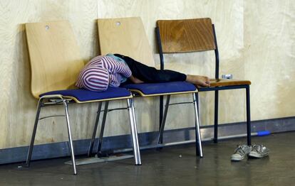 Um menino dorme enquanto espera para passar no primeiro controle para obter asilo em Passau, Alemanha.