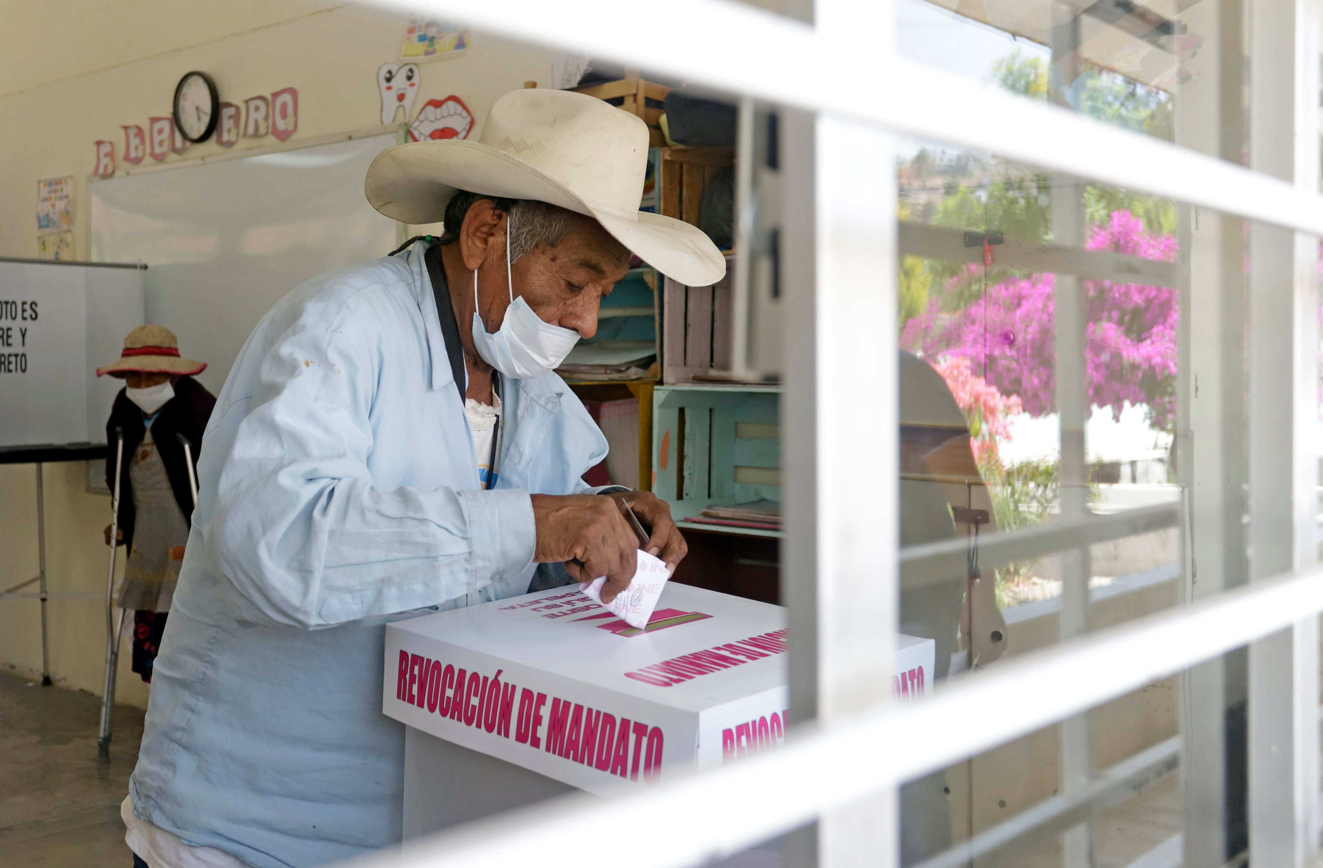 Un ciudadano emite su voto en la consulta de revocación de mandato, en Puebla (México), en abril de 2022.