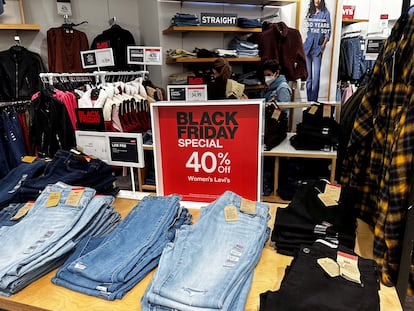 Shoppers look at clothes during Black Friday deals at Macy’s department store at the Roosevelt Field mall in Garden City, New York, U.S., November 24, 2023.