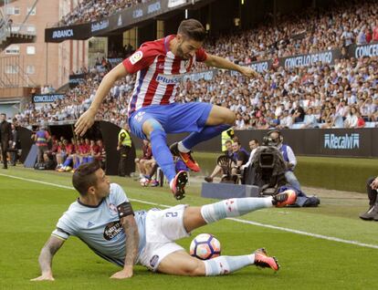 El centrocampista belga del Atlético de Madrid Yannick Carrasco (d) y el defensa del Celta de Vigo Hugo Mallo (i), durante el partido de la tercera jornada de Liga de Primera División disputado en el estadio de Balaídos.