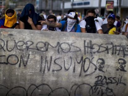 A group of demonstrators hold a march in Caracas on Sunday.