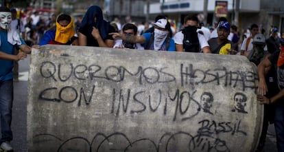 A group of demonstrators hold a march in Caracas on Sunday.