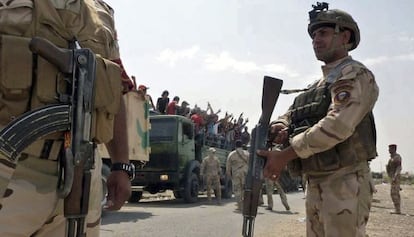 Soldados iraqu&iacute;es transportan voluntarios a una base en Bagdad.