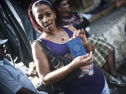 A Cuban migrant shows her passport at a shelter in La Cruz, Costa Rica.