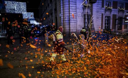 Los operarios limpian la Puerta del Sol tras las campanadas de Año Nuevo que concentraron a miles de personas.