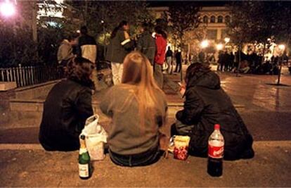 Unos jóvenes adolescentes, beben calimocho y litronas botellón, en la plaza de Barceló de Madrid.