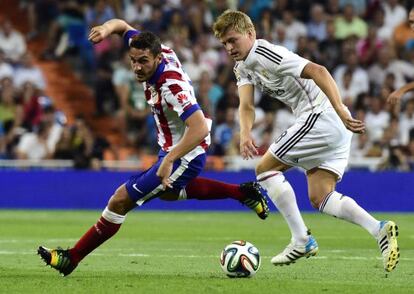 Kroos y Koke luchan por un balón.
