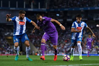 Karim Benzema trata de controlar el balón entre David López y Hernan Perez