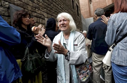 Una mujer sale entre aplausos después de votar.