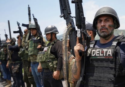 Alleged members of the CJNG pose with their weapons for the press, in Aguililla (State of Michoacán), in July 2021.