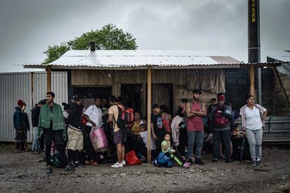 Decenas de migrantes se resguardan de la lluvia luego de ser retenidos en la estación migratoria Siglo XXI de Tapachula, Chiapas