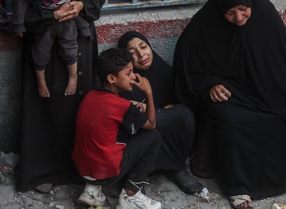 Several Palestinians cry near the UNRWA school, which houses thousands of people, after the Israeli attack.  The army has claimed that the airstrike targeted three rooms containing between 20 and 30 Hamas militiamen, some of whom participated in the October 7 attack.