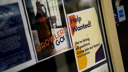 An employee hiring sign is seen in a window of a business in Arlington, Virginia, U.S., April 7, 2023.
