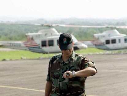 Un militar mira la hora durante el despegue de dos helicópteros de una base venezolana, rumbo a Colombia.