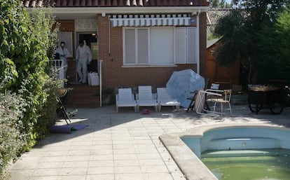 Forensics experts at the house where the family was murdered.