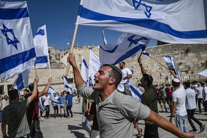 Jóvenes religiosos israelíes ondean su bandera nacional en el Muro de las Lamentaciones, en la Ciudad Vieja de Jerusalén, en apoyo a Israel, este jueves.