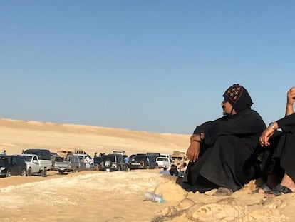 Dos hombres sentados tras el atentado de este viernes contra un grupo de coptos que viajaban a un monasterio al sur de Egipto. 