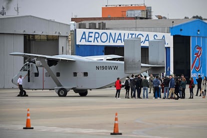 Members of human rights organizations, relatives and victims of the dictatorship, gather behind the Short SC-7 Skyvan aircraft used in the last Argentine military dictatorship (1976-1983) as it sits on the tarmac upon landing at Jorge Newbery International Airport in Buenos Aires, on June 24, 2023.