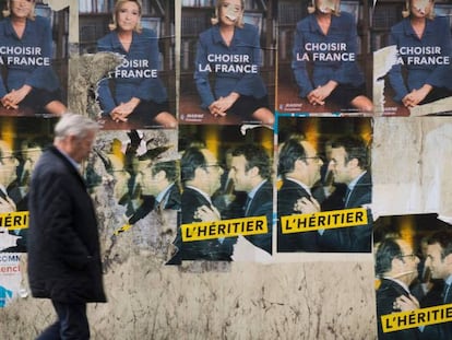 Un home passeja davant dels cartells electorals a París aquest divendres.