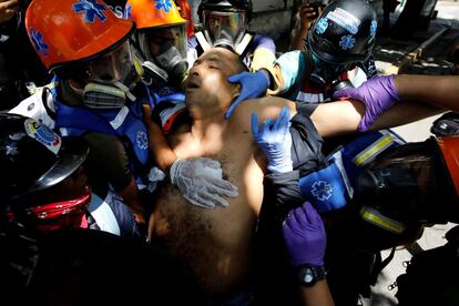 Un hombre herido es atendido durante una manifestación contra el gobierno de Maduro.