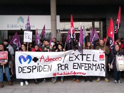 Extel workers at a protest with a sign that reads: “Fired for being sick.”