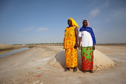 Mamah Coumba Sarr (de amarillo) y Awa Basse, tesorera y presidenta, respectivamente, de la asociación Diam Bougoum, comprueban el estado de los pozos que han hecho cavar en las salinas de Faoye para ver si la sal está lista para ser recogida.