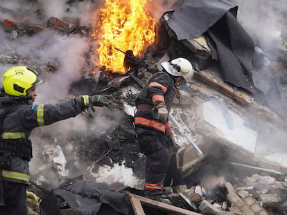 Rescuers work the scene of a building damaged by Russian rocket attack in Kharkiv, Ukraine, Tuesday, Jan. 23, 2024. (AP Photo/Andrii Marienko)