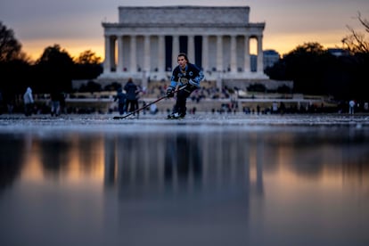 Jacek Zavora plays ice hockey on the reflecting pool at the Lincoln Memorial in the center of the US capital.