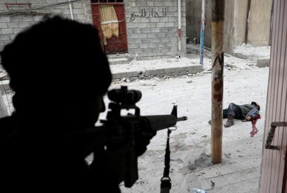 ATTENTION EDITORS - VISUALS COVERAGE OF SCENES OF DEATH OR INJURY An Iraqi special forces soldier shoots dead a would-be Islamic State suicide bomber in Mosul, Iraq, March 3, 2017. Goran Tomasevic: "I shot this picture while accompanying an Iraqi counter-terrorism military unit on a probe into an inner-city district of western Mosul held by Islamic State. I had spent some time "embedded" with the counter-terrorism force so they were relaxed in my presence and allowed me to follow every step of their advance. On this particular day we were moving slowly on foot through narrow side streets, with soldiers searching house-to-house to gradually clear the way forward. Turning a corner into a more exposed main street, we suddenly came under heavy fire from Islamic State, which forced us to race inside a nearby house for cover. In so doing, a soldier near me was fatally shot in the back, while once inside the house another was shot in the head by a sniper as I was speaking with him. We were in a very dangerous situation, pinned down by IS fire, though the militants were kept back for the time being by air strikes called in by the unit commander, plus intensified mortar fire from our side. Hours passed by and daylight faded to night. Suddenly soldiers near me began shouting, shooting broke out and I saw one soldier shooting a would-be IS suicide bomber trying to approach the house door. I took the picture seconds later standing just behind the shooter in silhouette, with the suicide bomber visible through a shell hole in the house wall, dead on the ground in a spreading pool of blood. It was pretty heavy stuff, extremely close-range war fighting. But I have covered the front lines of many wars so I just stay calm in these tough spots and think only how I can shoot the best pictures while seizing the right moment to pull back out of harm's way. This time, we had to wait until just after dawn the next day to retreat, darting from one street corner to the next to reach safety b