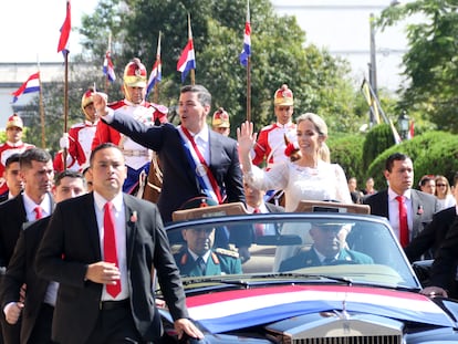 The new president of Paraguay, Santiago Peña, and the first lady, Leticia Ocampos, greet supporters during a car ride after the inauguration ceremony on Aug. 15, 2023.