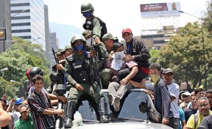 Soldados, com seguidores de Juan Guaidó nesta terça-feira