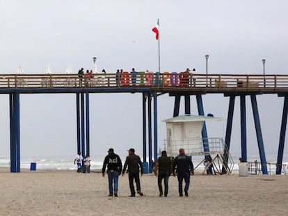 Security agents walk along Rosarito beach after the disappearance of the three foreign tourists in Baja California on May 2.