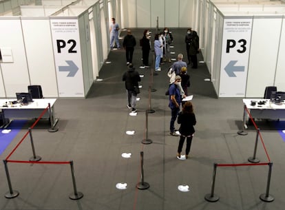 People wait in line for their Covid-19 vaccine at the Bilbao Exhibition Centre on Saturday.