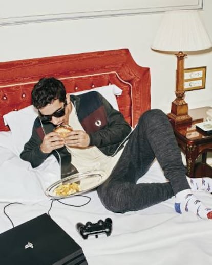 Javier viste pantalón ‘jogger’ y calcetines Reebok, chaqueta Fred Perry y camiseta COS. las gafas son Tom Ford y la consola, una PS4 Pro de Sony.