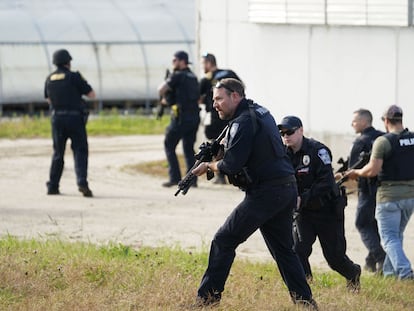 Law enforcement officers search a farmhouse as the manhunt for the suspect continues in Maine, October 27, 2023.